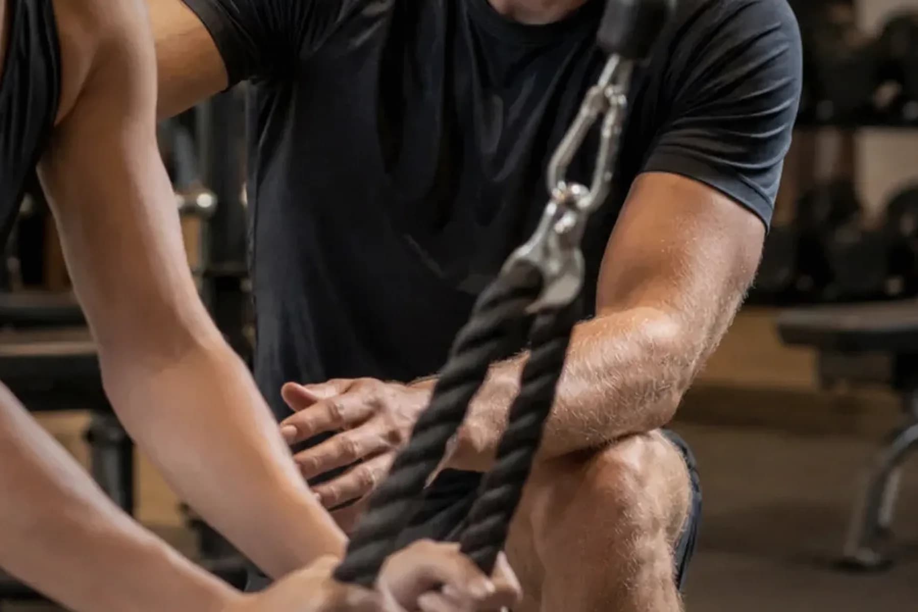Close detail of hands and cable rope during a coached training session